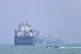 A small motorboat passes anchored vessels in the Strait of Hormuz off Bandar Abbas, Iran, June 11, 2026