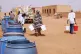 People fill water containers at a free distribution point amid water outages in Khartoum, Sudan, May 18, 2026