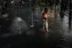 A boy cools off at a fountain on a hot day, in London, June 25, 2026