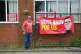 A person poses next to a banner at the Community Sports Club in Makerfield, Greater Manchester, June 17, 2026