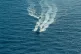 A Libyan coastguard ship blasts past one of the Open Arms Rh