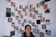 Yelena Monroy poses for portrait by photos of detainees who 