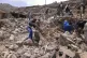 Villagers scour rubble for belongings scattered during the b
