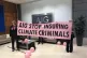 Extinction Rebellion activists protest in the lobby of AIG T