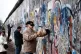 LETTING THE RIGHT IN: Men chip away at the defunct Berlin wa