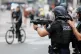 French police aim a gun at protesters