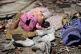 A child’s shoe and clothes are left at a site of Saudi-led