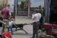 A child plays with a gun at an Armed Forces Day event