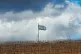 An Israeli flag waves on the top of a hill near the so-calle