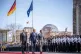 DOWNWARD SKID: German Chancellor Olaf Scholz (left) reviews 