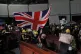 A woman carries the British flag as she joins other proteste