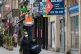 STRICKEN: A woman walks past shops to let in Leicester, whic