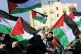Women wave their national flags during a rally marking the 4