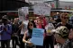 People hold placards as they attend an RMT rally outside of 