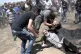 An elderly Palestinian man falls on the ground after being s