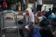 MISERY: A woman sits on the curb next to her belongings outs