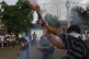 An anti-government demonstrator fires a homemade mortar duri