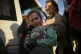 A child and her family who fled from Mariupol arrive at a re