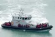 A group of people are brought in to Dover, Kent, onboard a B
