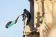 A man holds a Palestinian flag after he climbed up Elizabeth