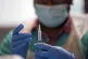 A pharmacist preparing the vaccine in a pop-up vaccination c