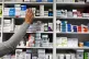 A pharmacist stocking shelves at a chemist