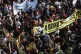 People holding a banner depicting Greek rap singer Pavlos Fy