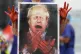 A nurse holds a painting of Prime Minister Boris Johnson cla