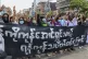 Anti-coup protesters flash the three-finger salute, holding 