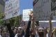 Palestinian women chant slogans while taking part in an anti