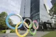 A man walks past the Olympic rings in Tokyo