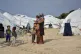 A woman holds a baby at Karatepe refugee camp, on the easter