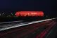 Cars pass the illuminated 'Allianz Arena' stadium in Munich,
