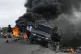 Police abandon their vehicle during a demonstration that tur