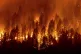 A fire burns down a hillside in Plumas County, California, i