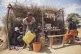 A woman using a tiny amount of water she bought at a kiosk i