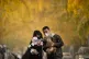A couple wearing face masks holds their dogs as they pose fo