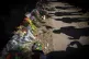 Visitors cast shadows at a memorial to the victims of the As