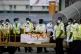 Sri Lankan air port workers stand next to a casket carrying 