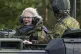 German Defence Minister Christine Lambrecht (left) rides in 