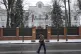 A pedestrian crosses the street in front of Chinese embassy 