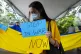 A Ukrainian woman living in Panama holds an anti-war sign du