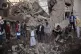 People gather at the site of a Saudi-led airstrike near Yeme