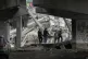 Ukrainian soldiers carry a body of a civilian killed by the 