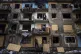 Local residents close the windows of an apartment building w