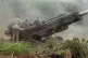 Ukrainian soldiers prepare to fire at Russian positions from