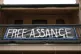 A sign in support of WikiLeaks founder Julian Assange hangs 