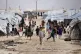 Children gather outside their tents, at al-Hol camp, which h