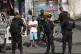 Police stand guard in the Complexo do Alemao favela in Rio d