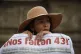 A woman carries a banner that reads in Spanish ‘We are mis